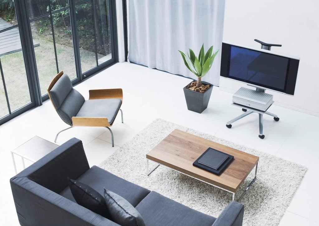 A bright, modern living room with a smart TV on a stand